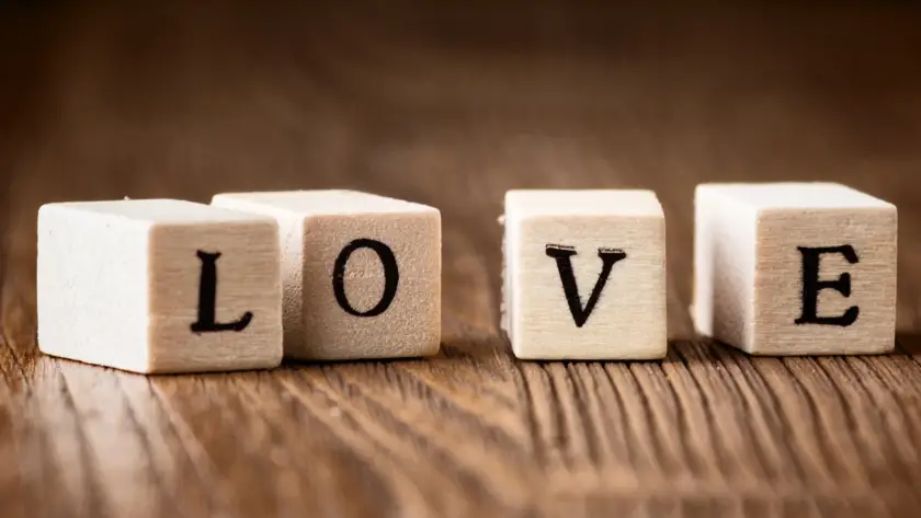 Wooden letter blocks spelling LOVE on wooden surface