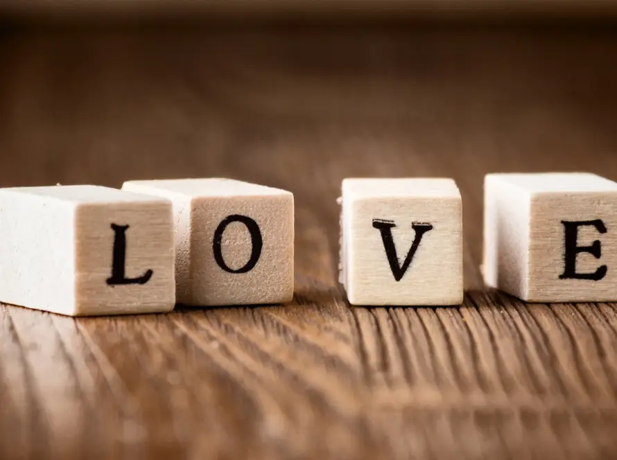Wooden letter blocks spelling LOVE on wooden surface